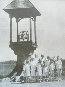 Children stand in front of Homme Center Bell